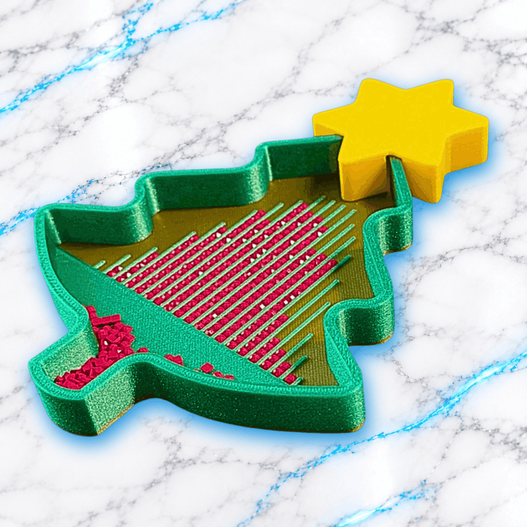 Plateau 3D Diamond Painting Sapin de Noël UnBrunBarbu vu en perspective, avec bordures vertes pailletées, étoile jaune, fond doré et diamants carrés roses alignés dans les rainures.